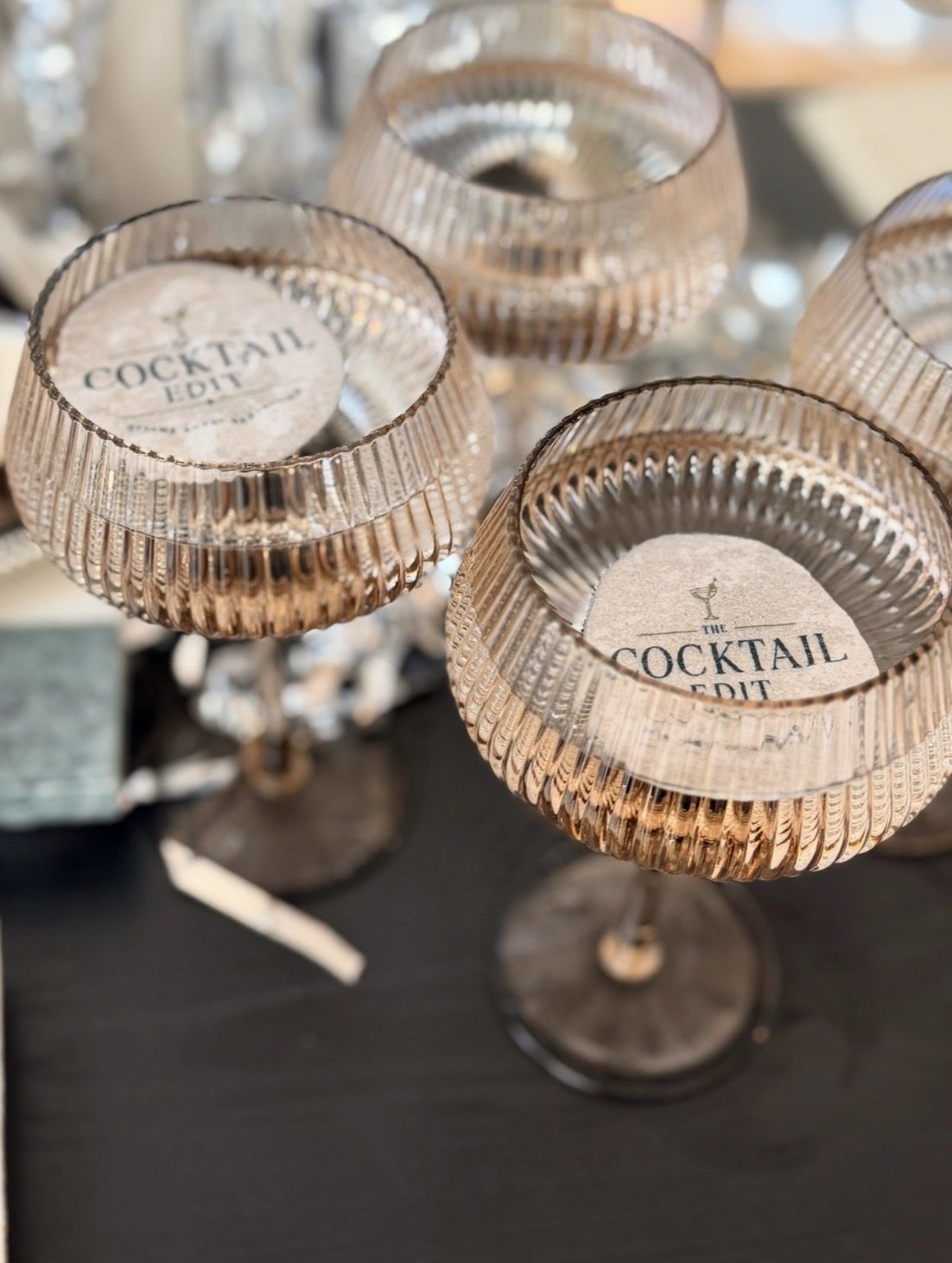 Coupe glasses with The Cocktail Edit coasters