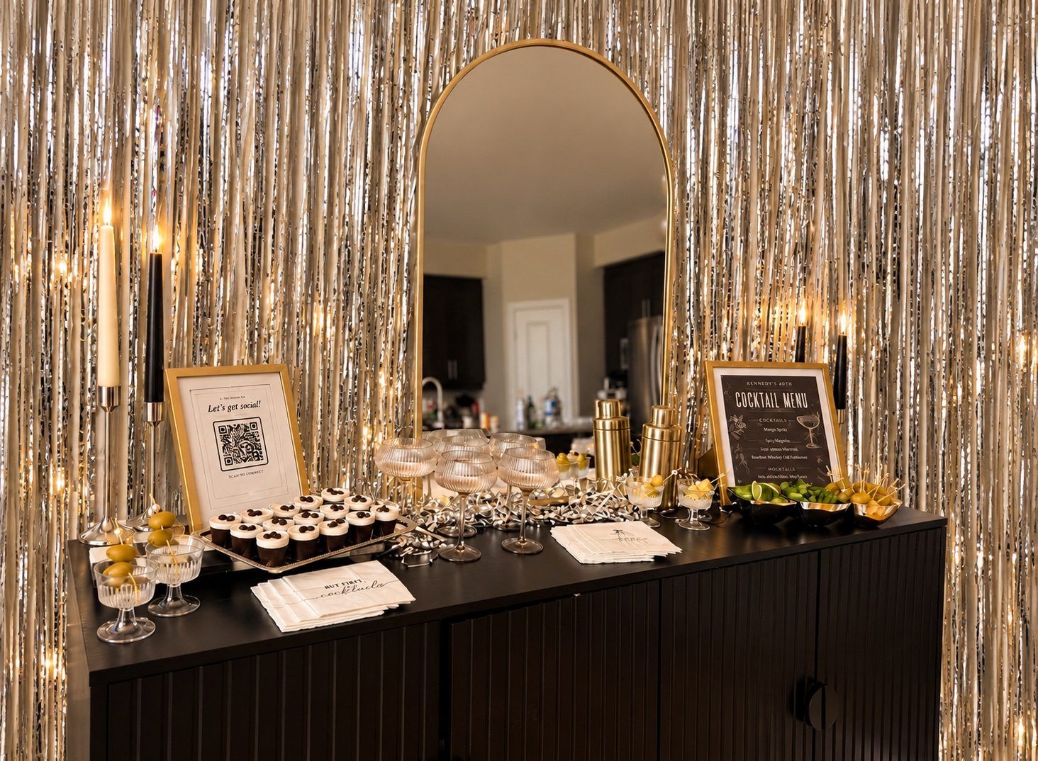 A home bar set against a gold tinsel backdrop, with a framed cocktail menu and espresso martini shots
